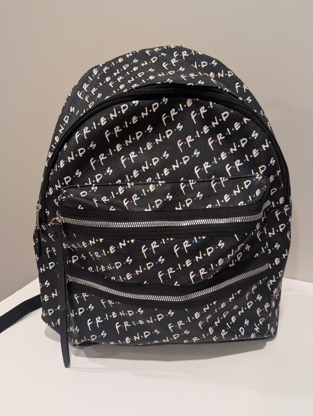 Friends Backpack all over print. need small repair see zoomed in photo